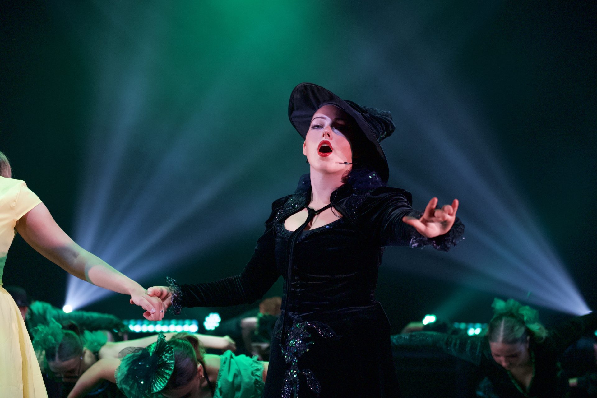 A women wearing black hat and black dress